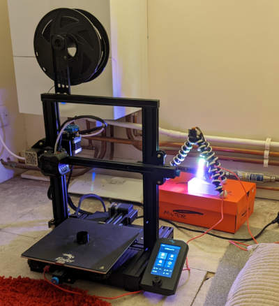 photo of 3d printed coin holder being printed lit by blinkt