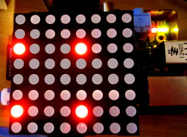 Raspberry Pi with PI Matrix board attached with the LED matrix attached upside down causing only four LEDs to light